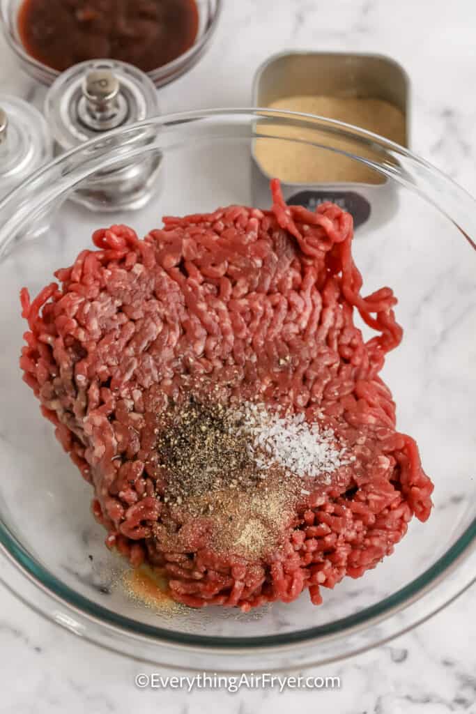 ingredients to make hamburger patties in a bowl