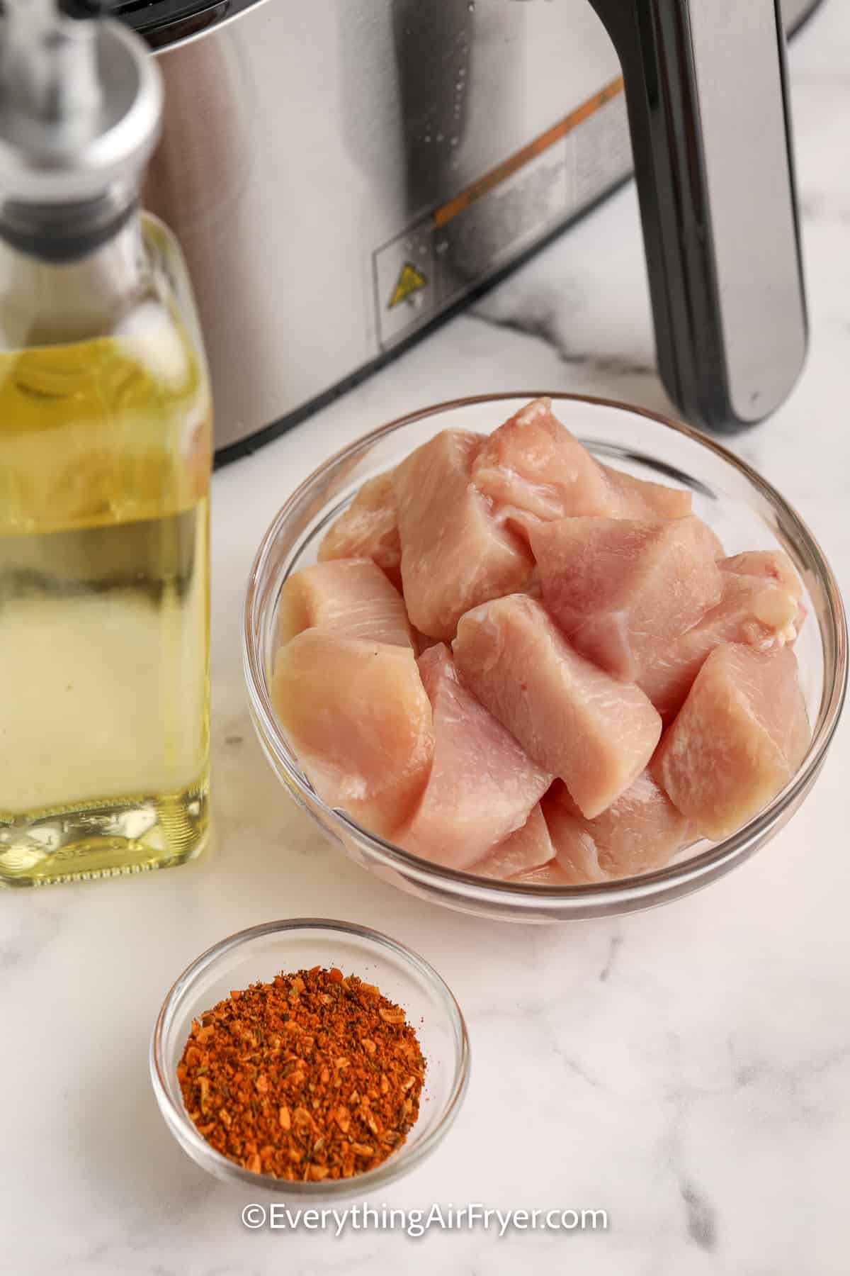 cubed raw chicken in a bowl