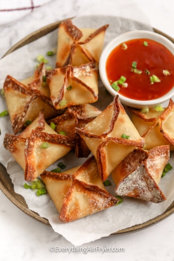 close up of cooked wontons on a plate