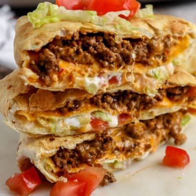 Three cross slices of air fryer crunchwrap supremes on a serving plate