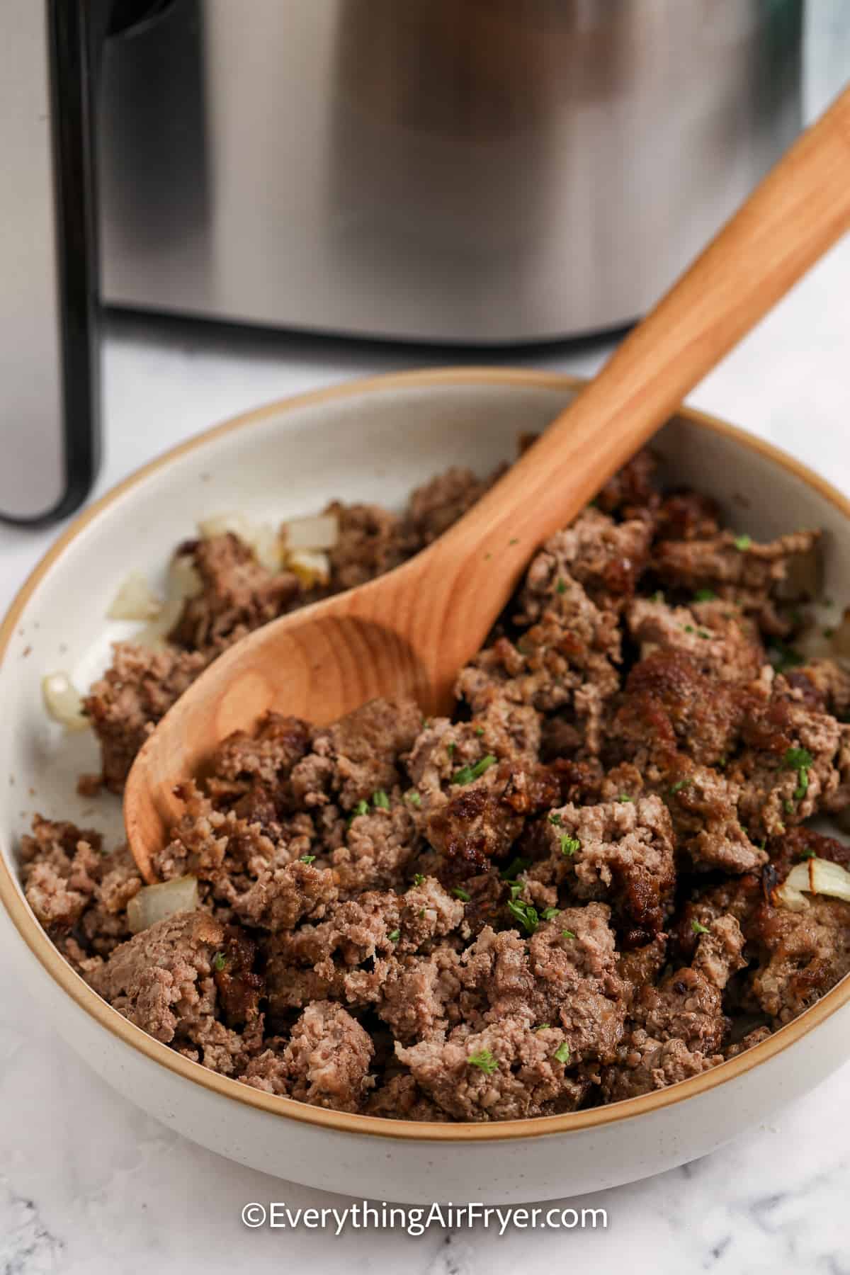 cooked ground beef in a bowl garnished with parsley