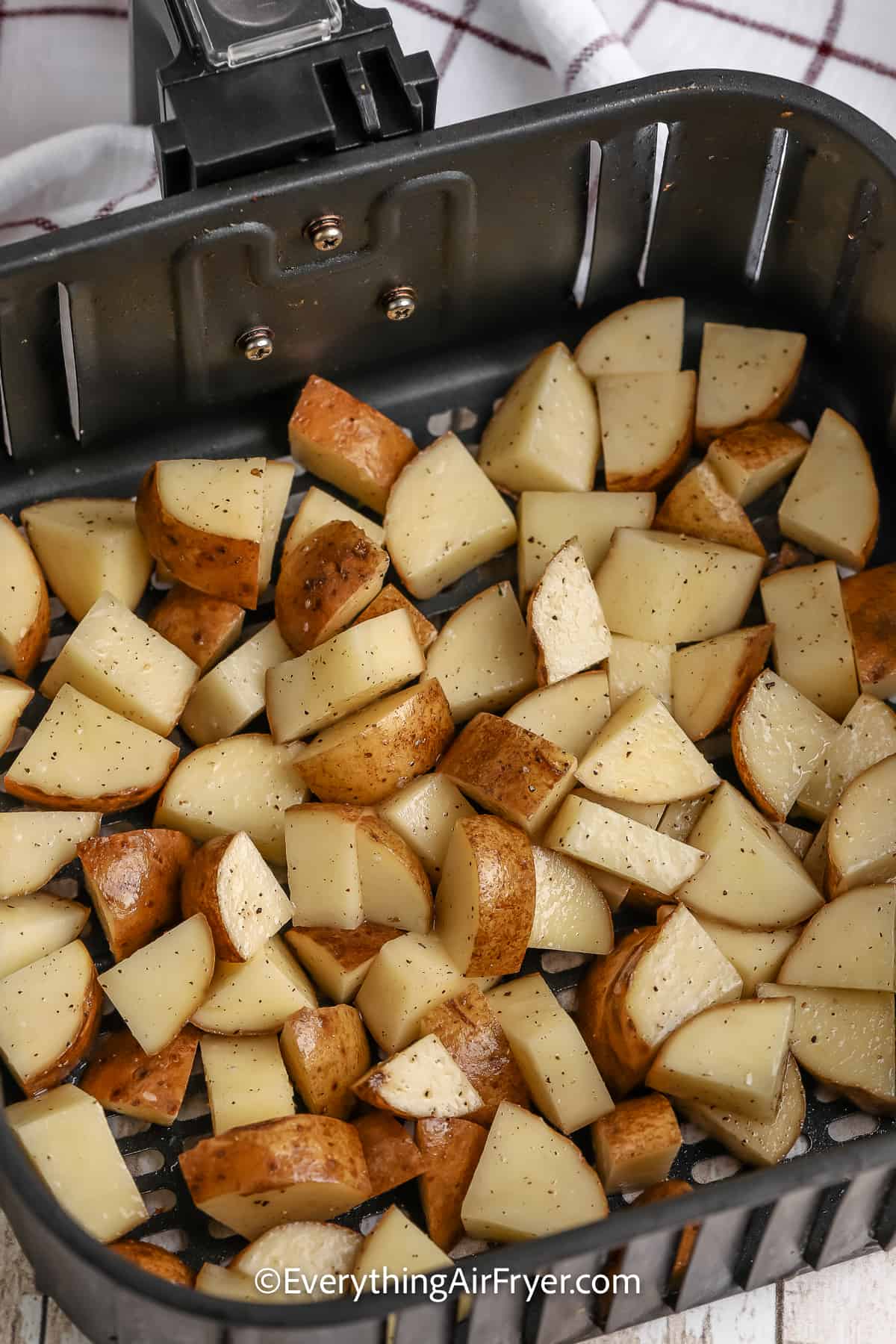 diced potatoes in an air fryer tray