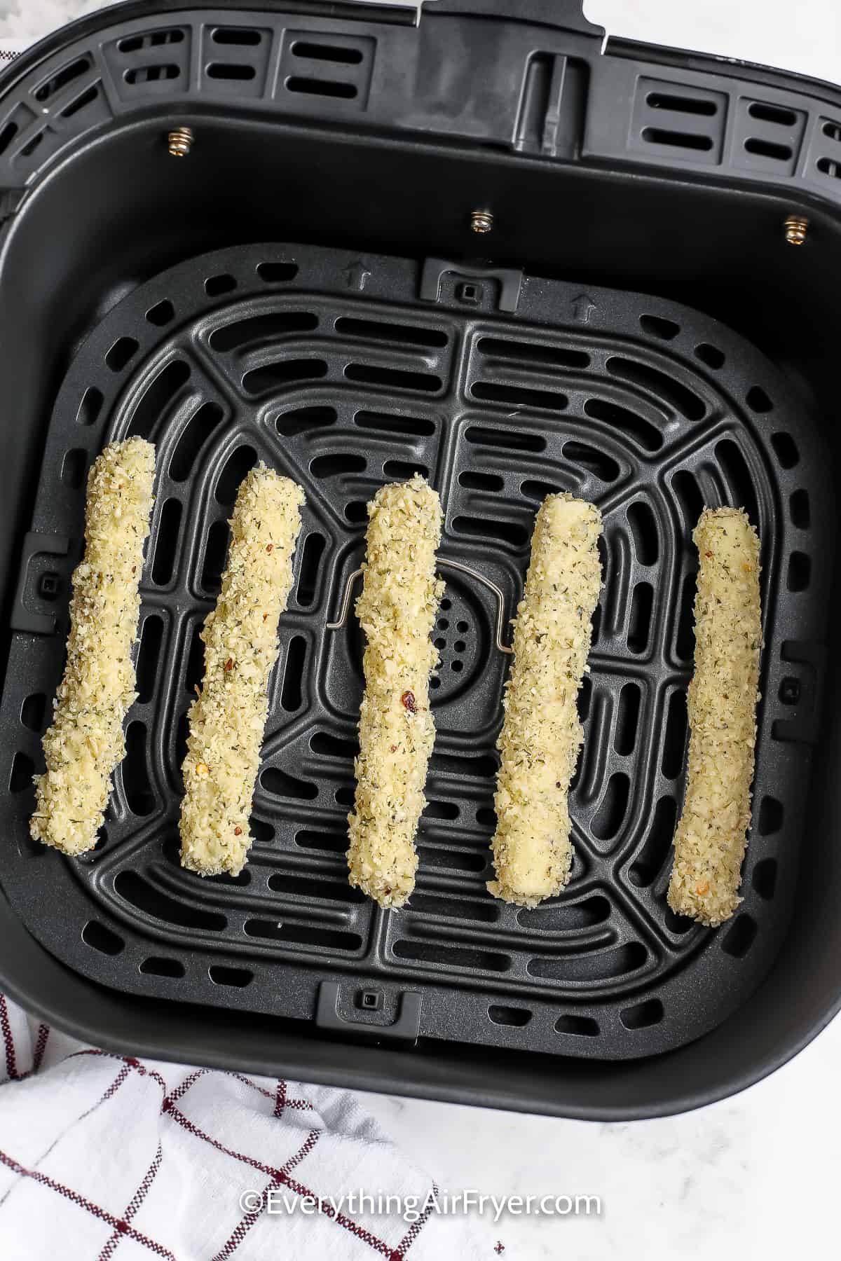 Prepped Mozzarella Sticks in an Air Fryer basket