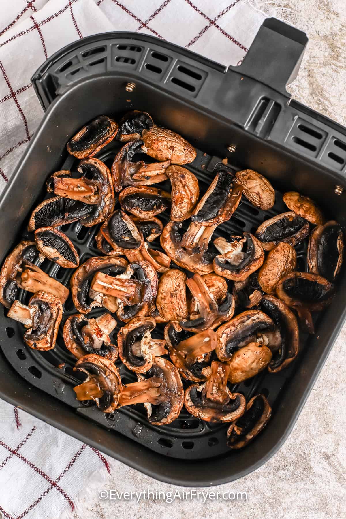 cooked mushrooms in an air fryer tray