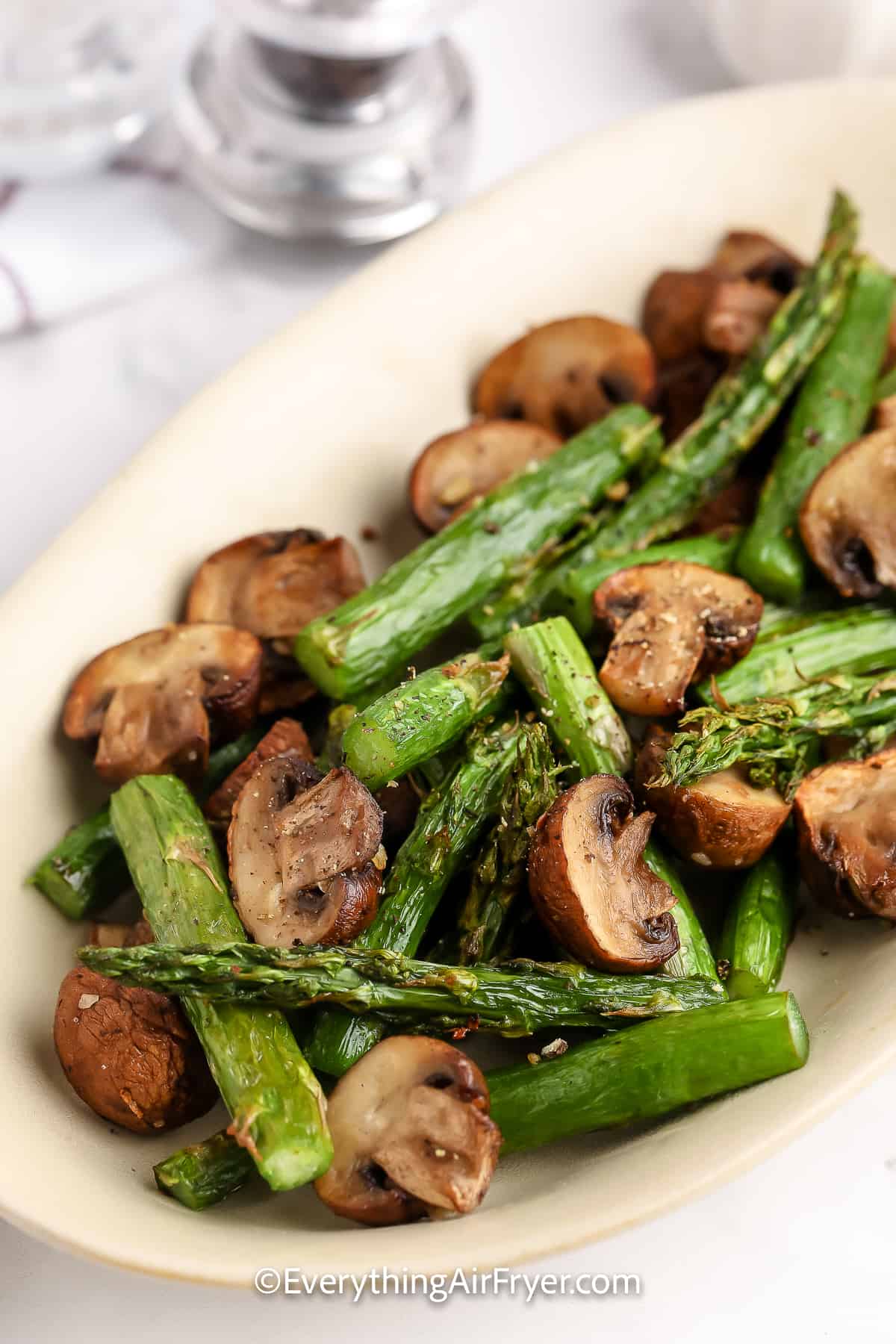 Air Fryer Mushrooms and Asparagus in a serving plate.