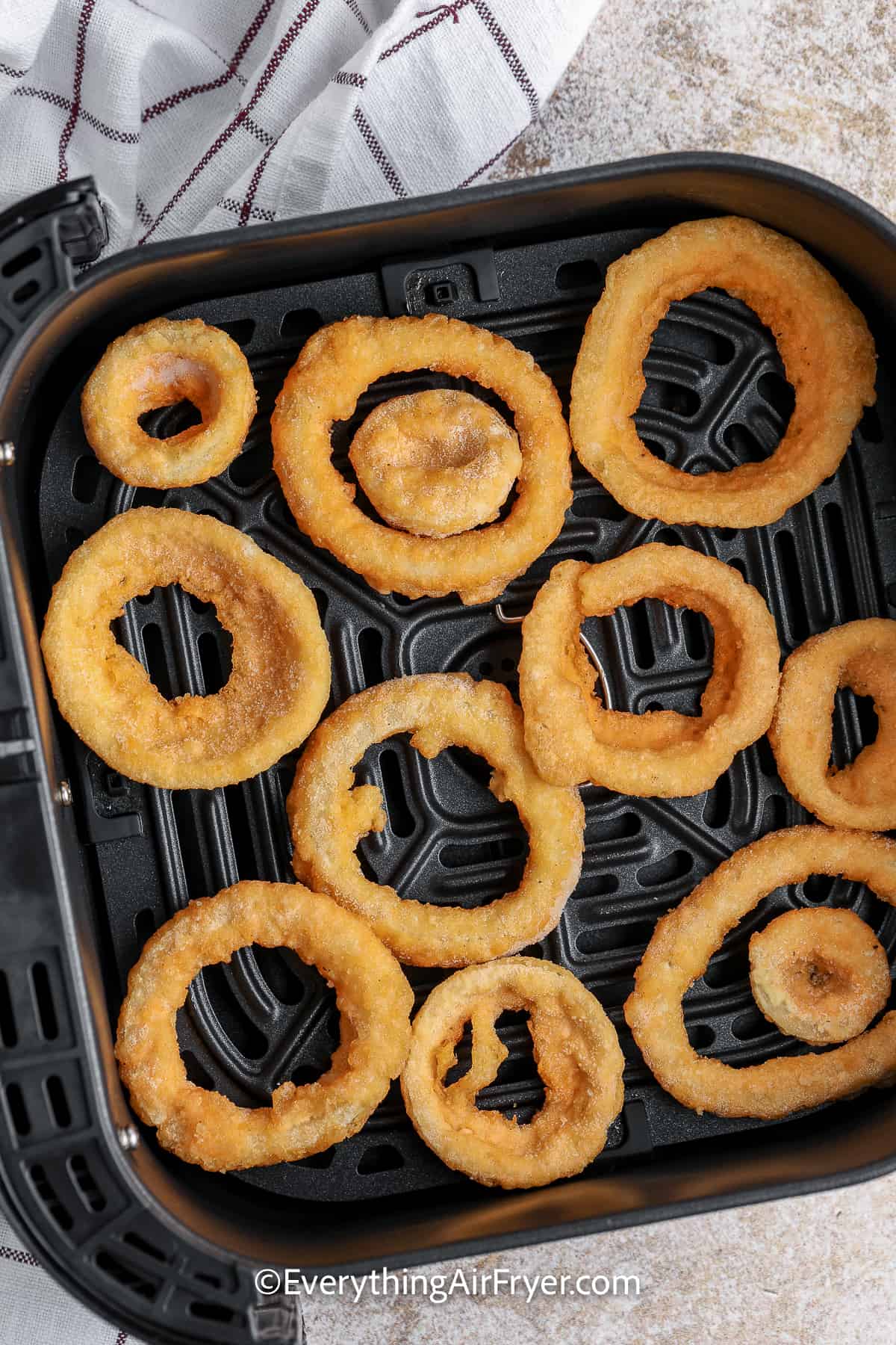frozen onion rings in an air fryer tray