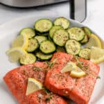 Cooked Air Fryer Salmon and Zucchini garnished with lemons