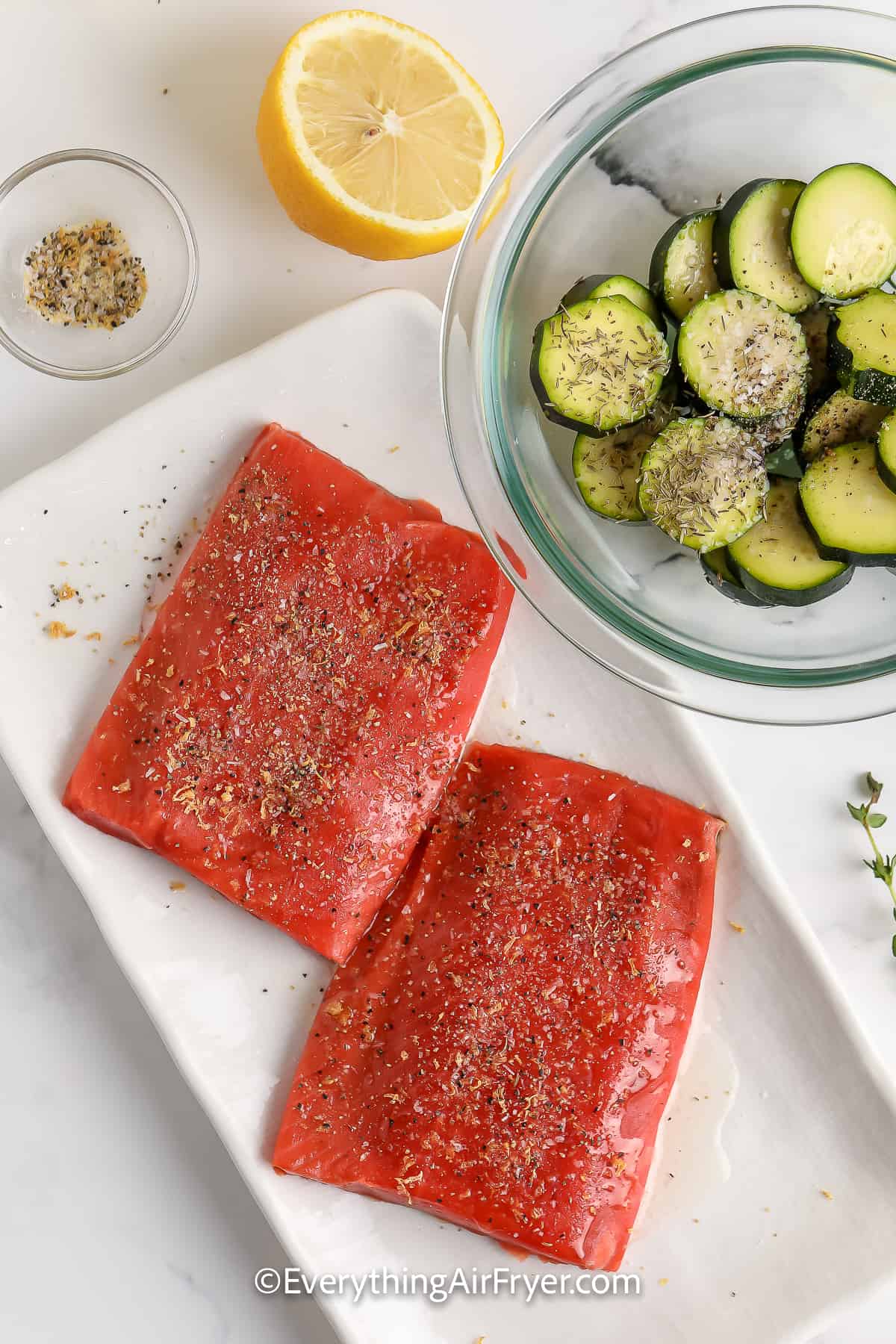 seasoned salmon on a plate with zucchini