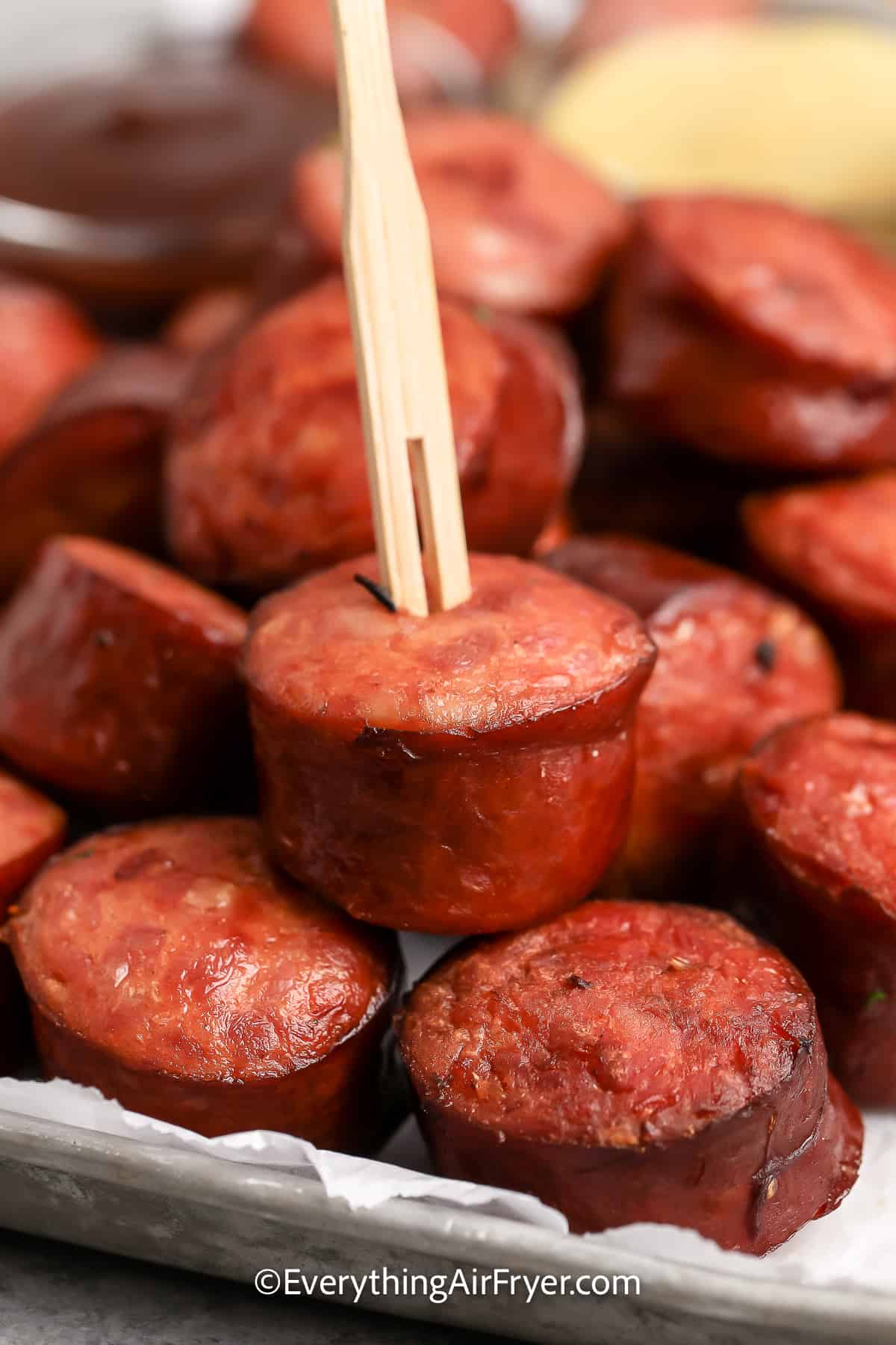 Air Fryer Smoked Sausage with a serving pick in it.