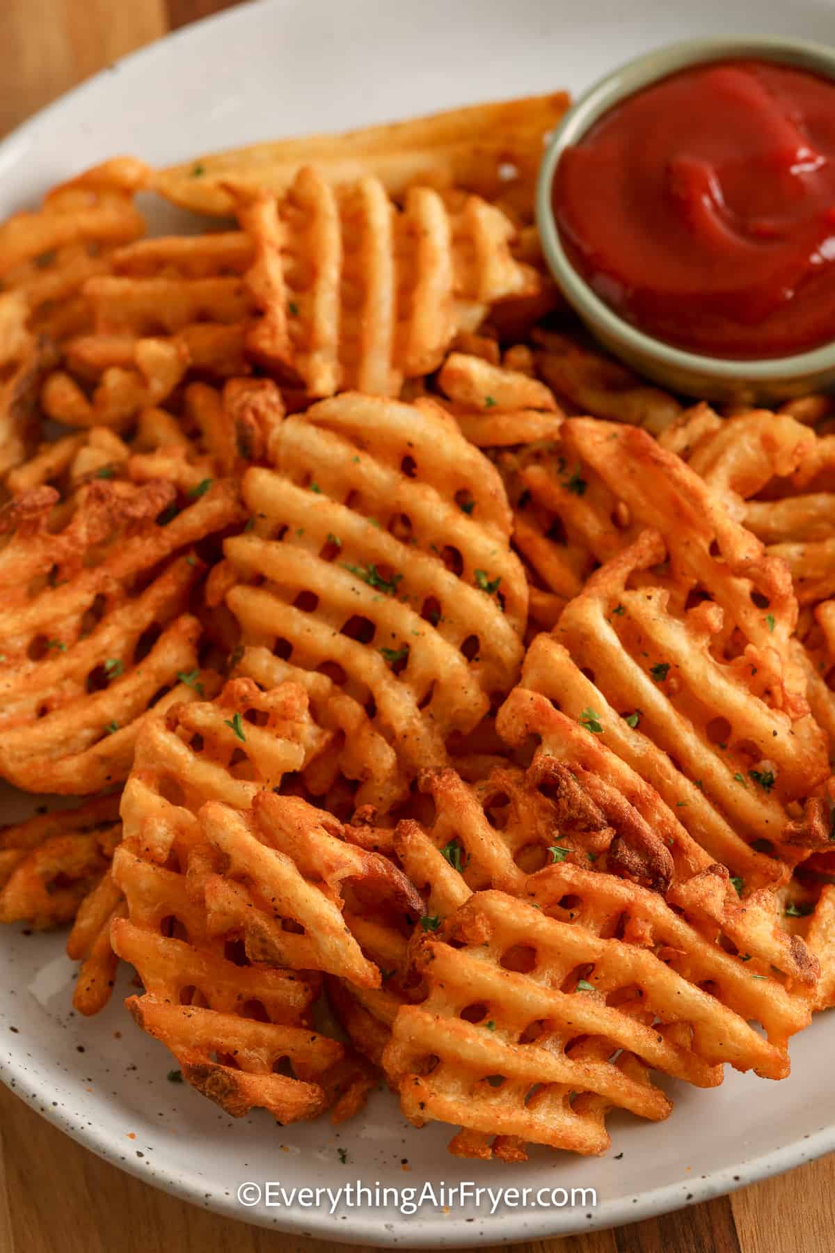 waffle fries on a plate with ketchup