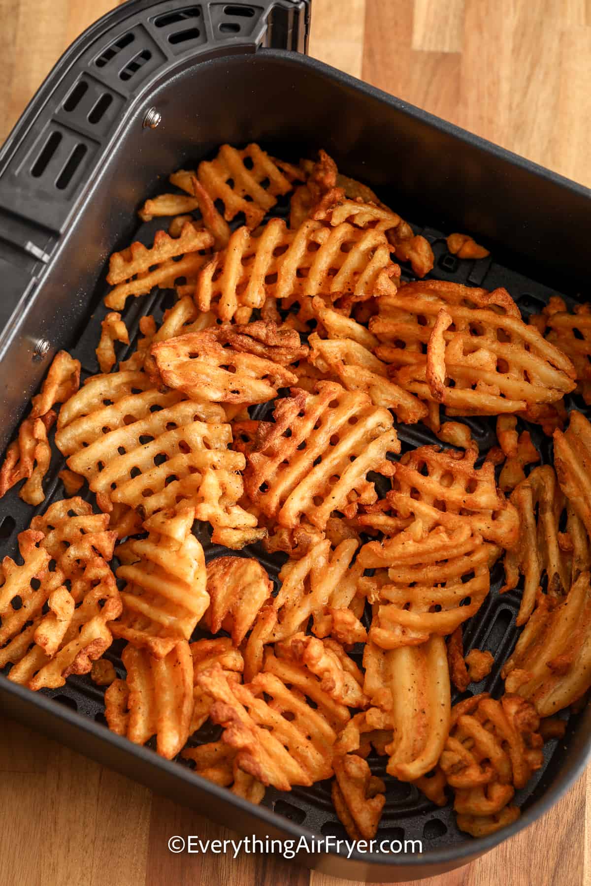 waffle fries in an air fryer tray