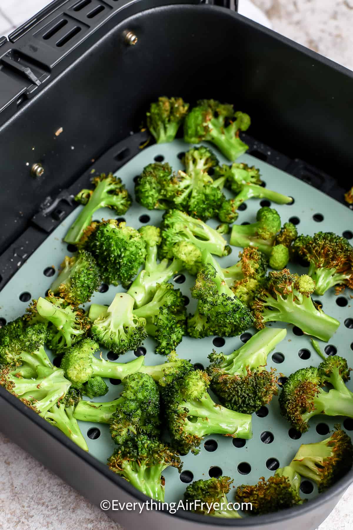 Broccoli cooked in an air fryer basket