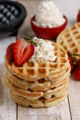 stack of eggo mini waffles with whipped cream and strawberries