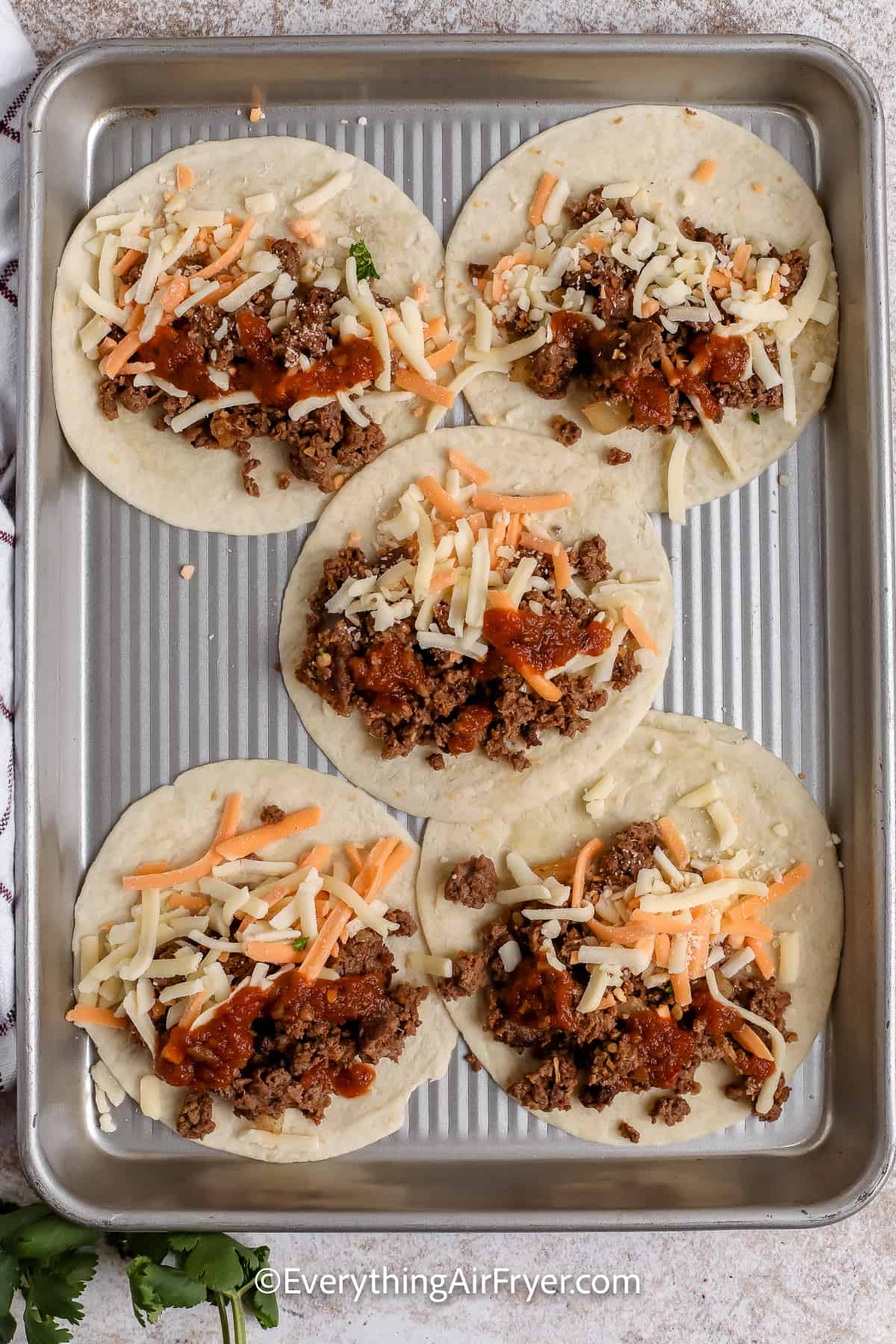 tortillas with taco fillings on a tray