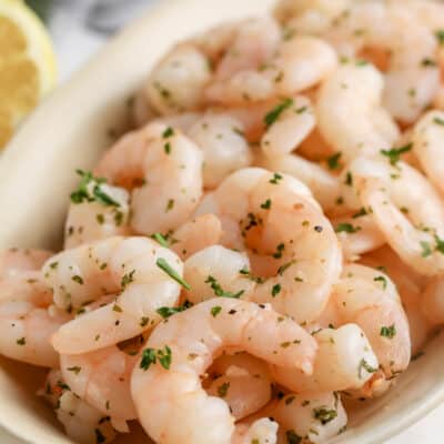 air fryer shrimp in a bowl topped with parsley