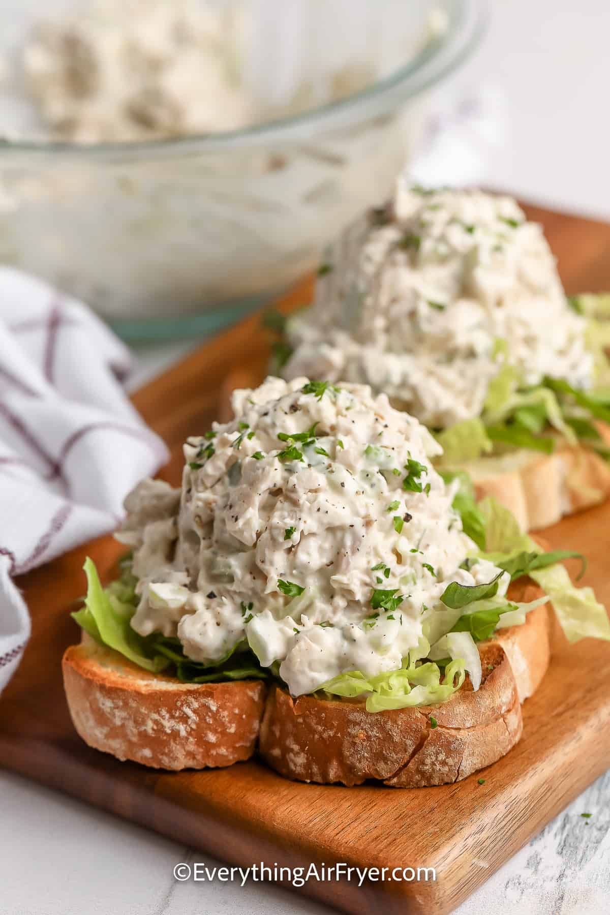 Chicken salad served on top bread and shredded lettuce