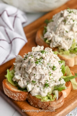 Chicken salad served on top bread and shredded lettuce