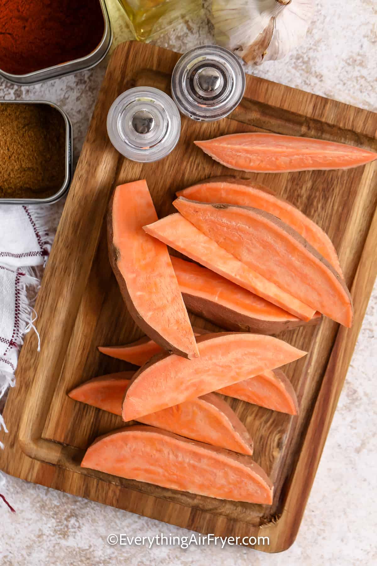 sliced sweet potato wedges on a cutting board