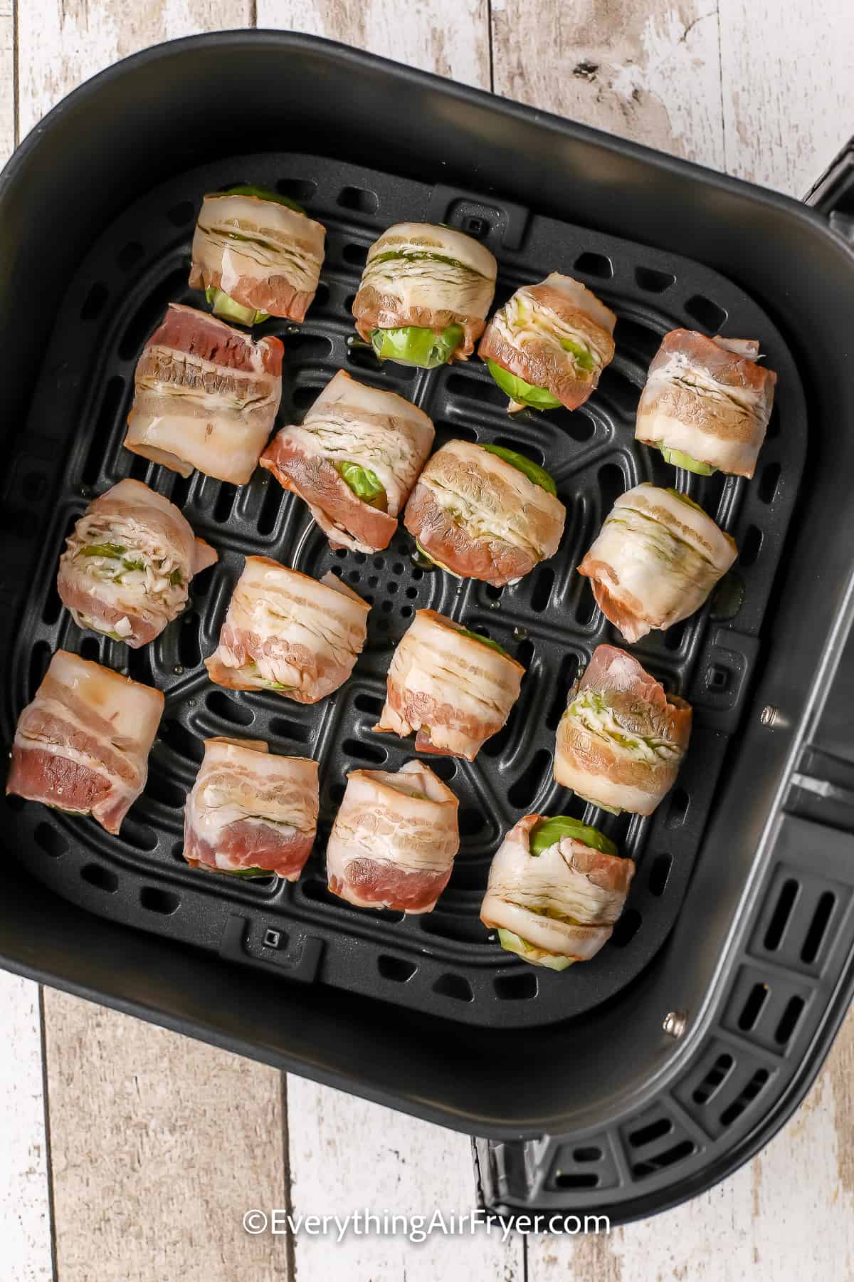 Bacon Wrapped Brussels Sprouts in an air fryer basket