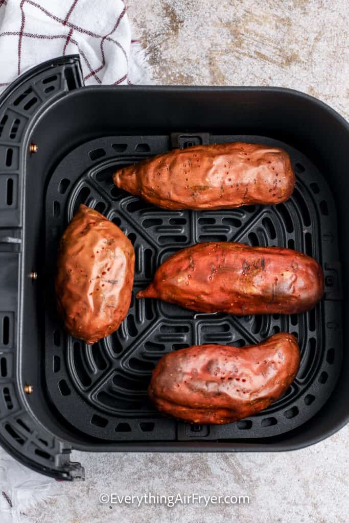 baked sweet potatoes in an air fryer tray