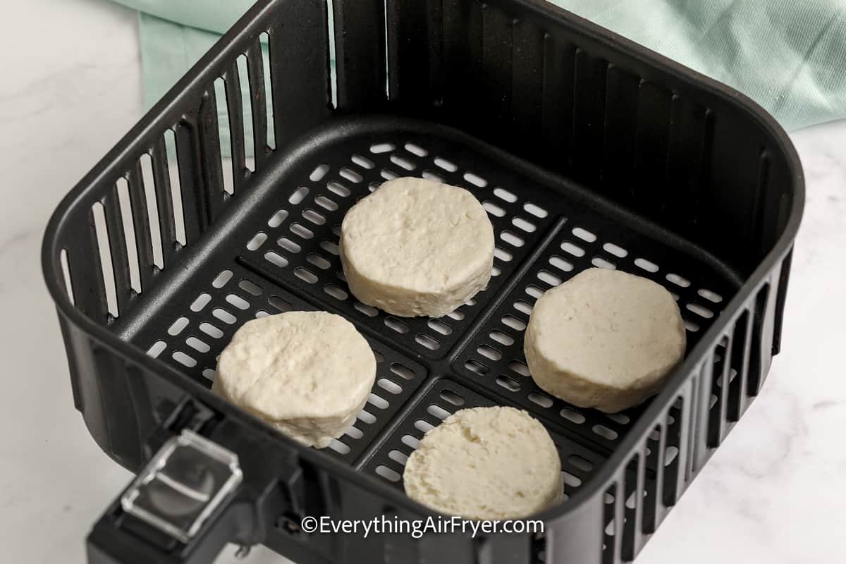 uncooked biscuits in an air fryer tray
