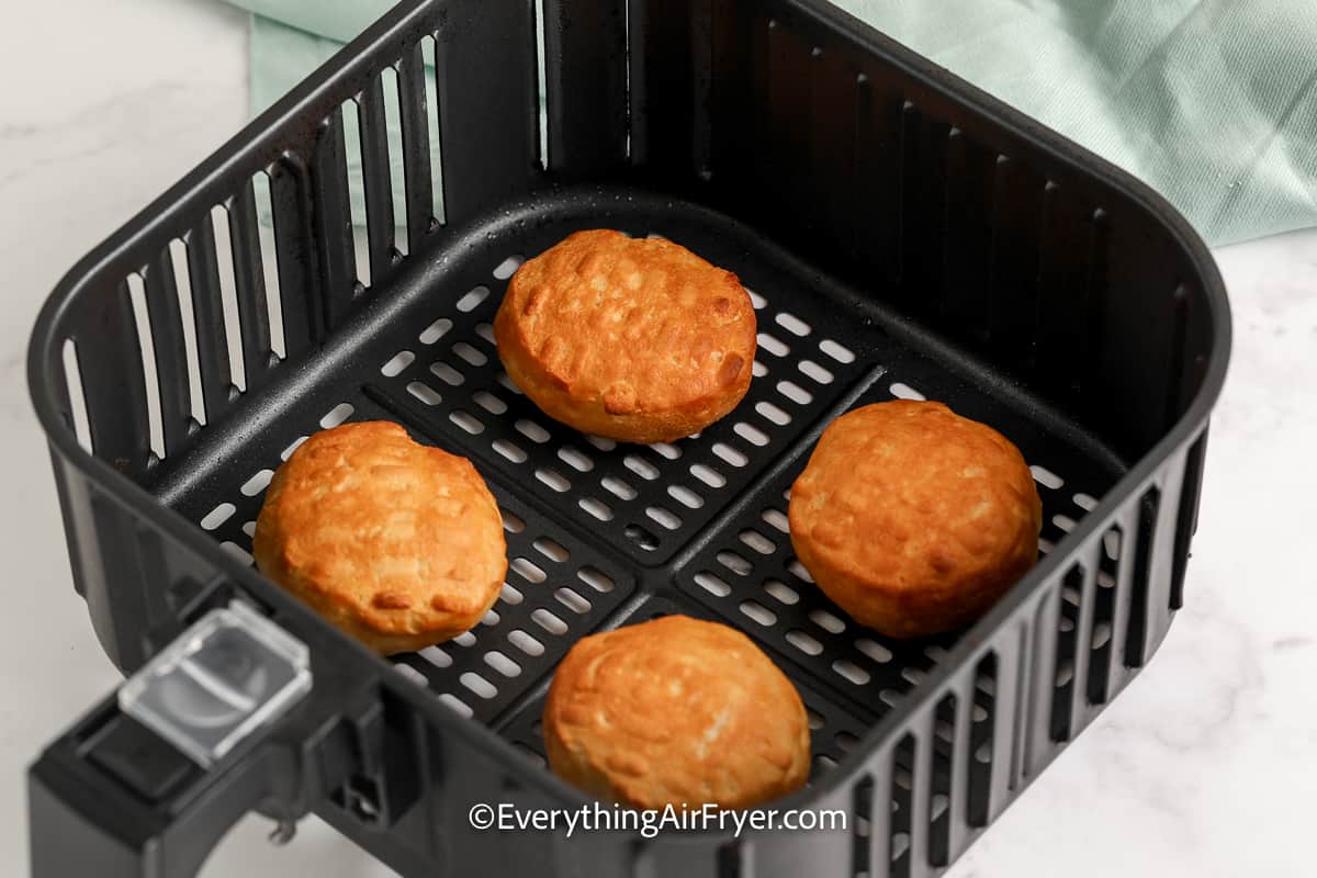 cooked biscuits in an air fryer tray