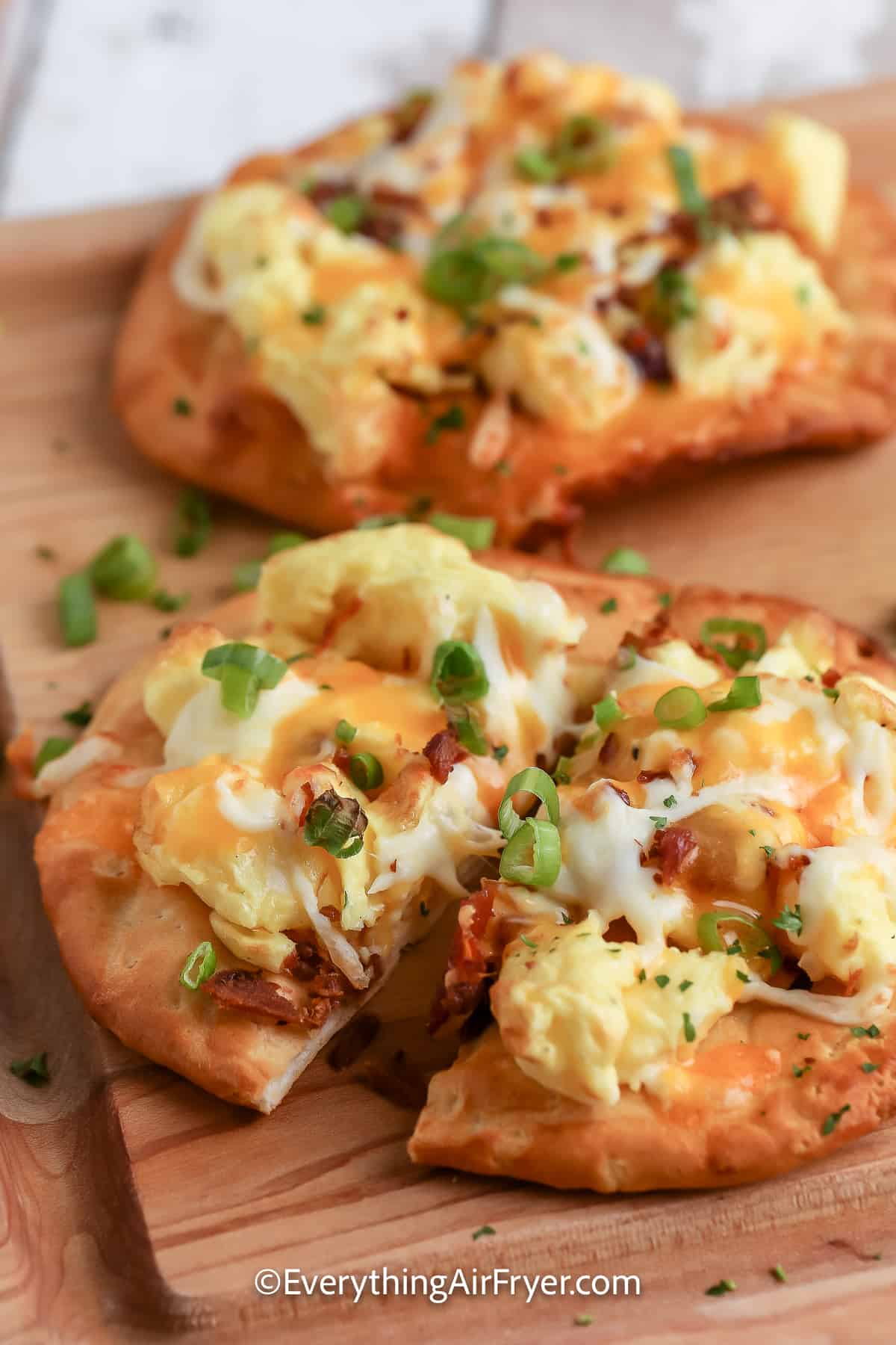 Air Fryer Breakfast Pizza with biscuit crust on a cutting board