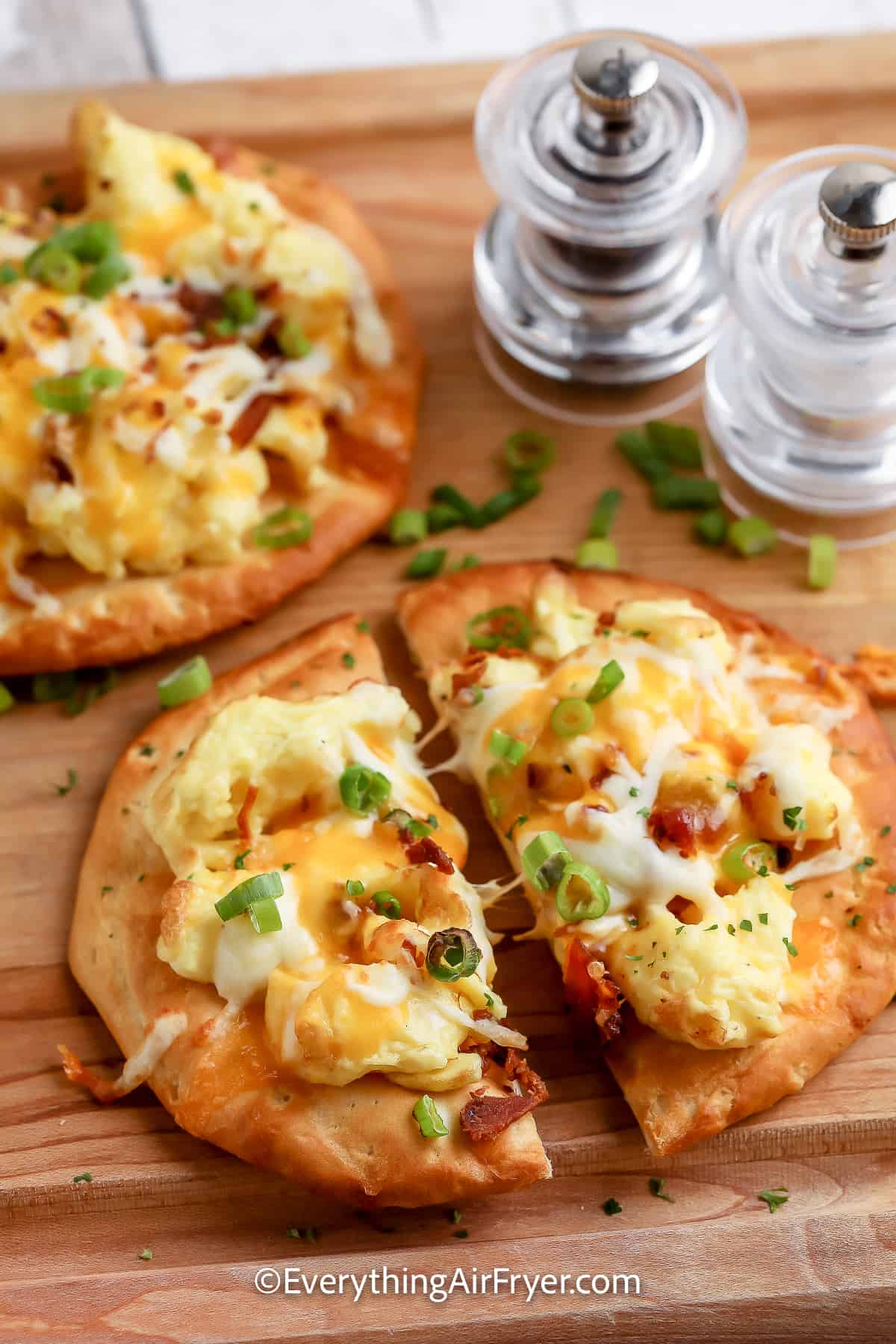 Air Fryer Breakfast Pizza with biscuit crust sliced on a cutting board