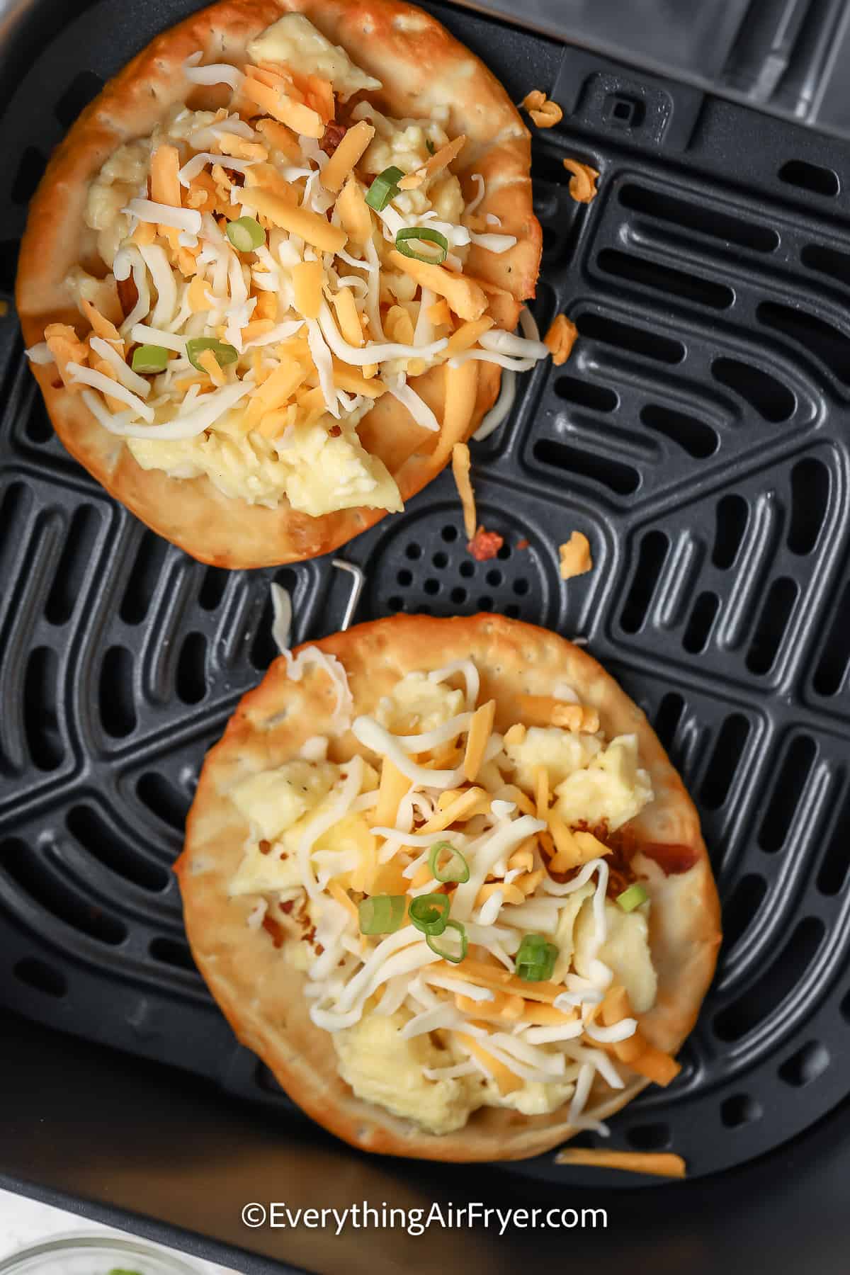 Breakfast Pizza with a Biscuit crust in an air fryer basket