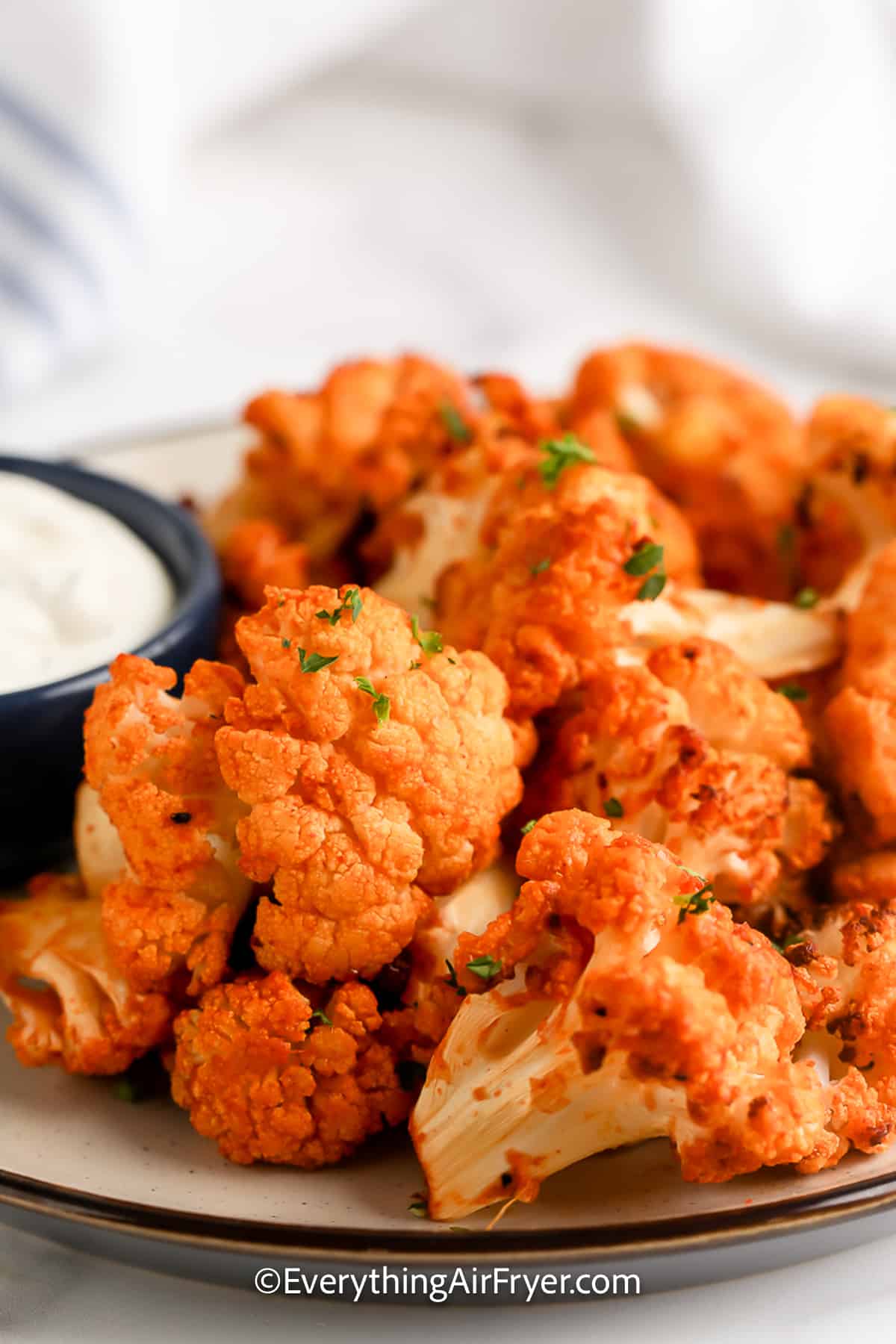 A plate of Air Fryer Buffalo Cauliflower with dipping sauce on the side