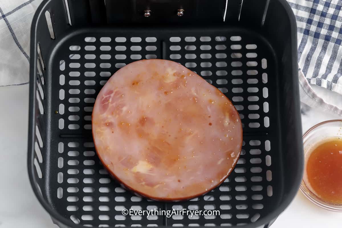 Ham Steak stopped with a glaze in an air fryer basket