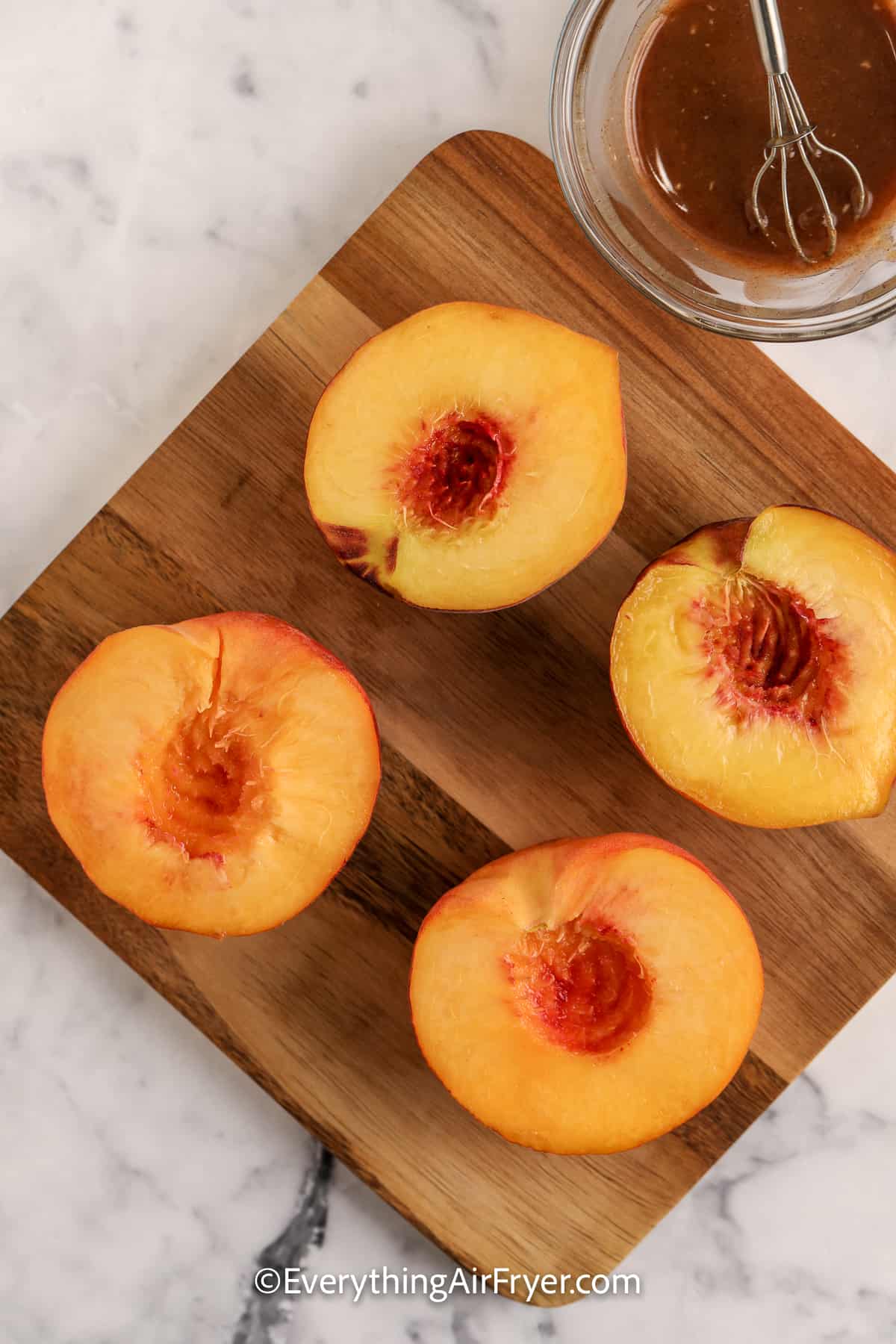 halved peaches on a cutting board