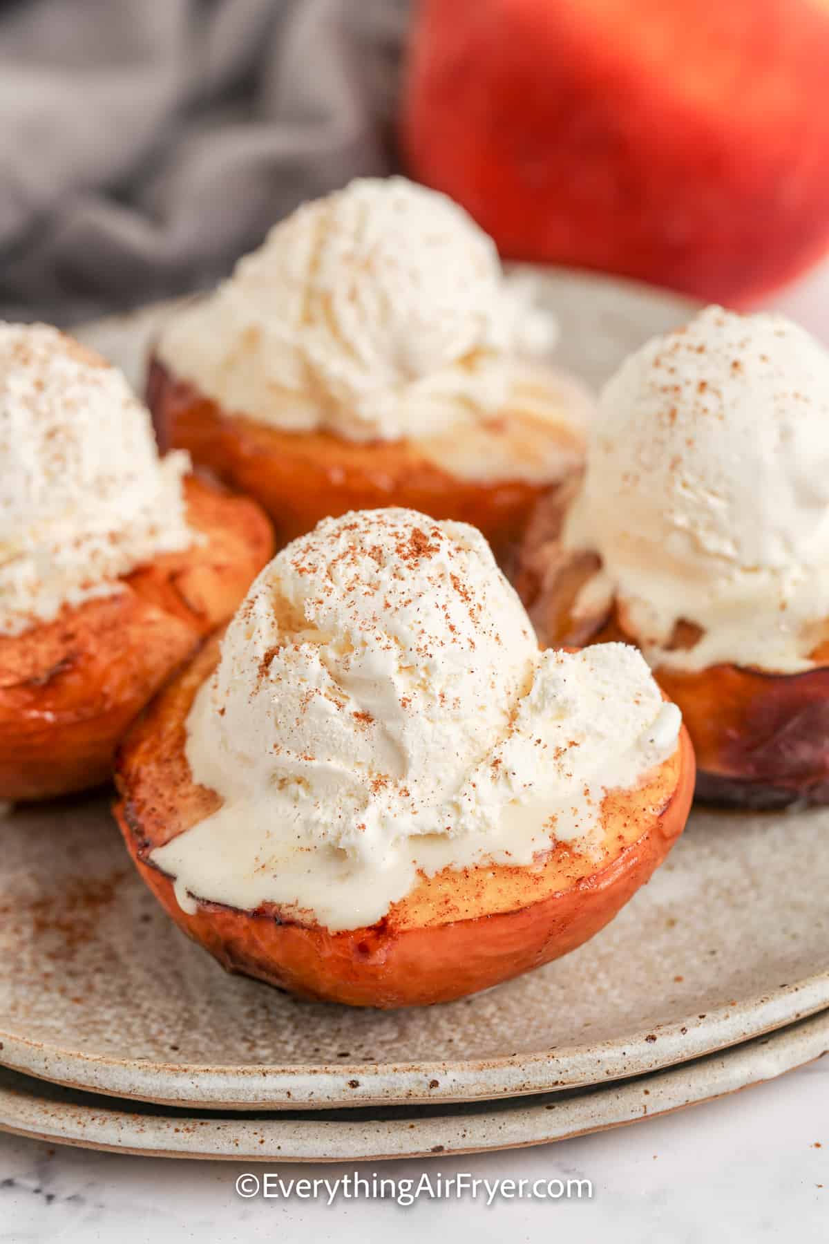 air fryer peaches topped with ice cream