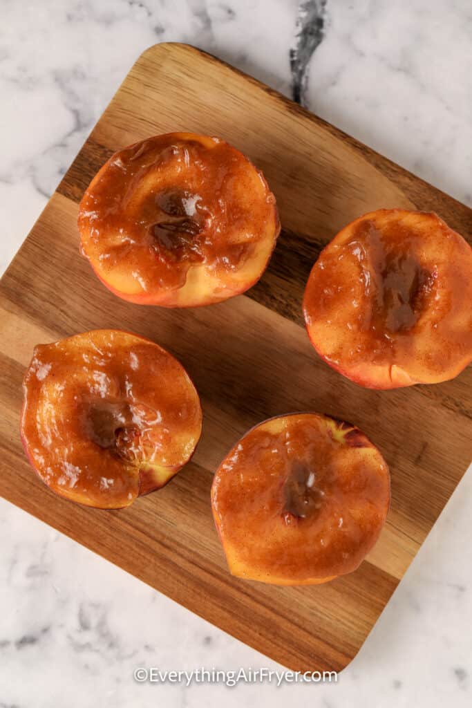 halved peaches topped with glaze