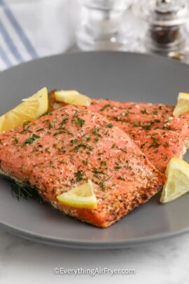Air Fryer Salmon with Dill garnished with lemon and dill