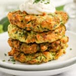 air fryer zucchini fritters stacked on a plate