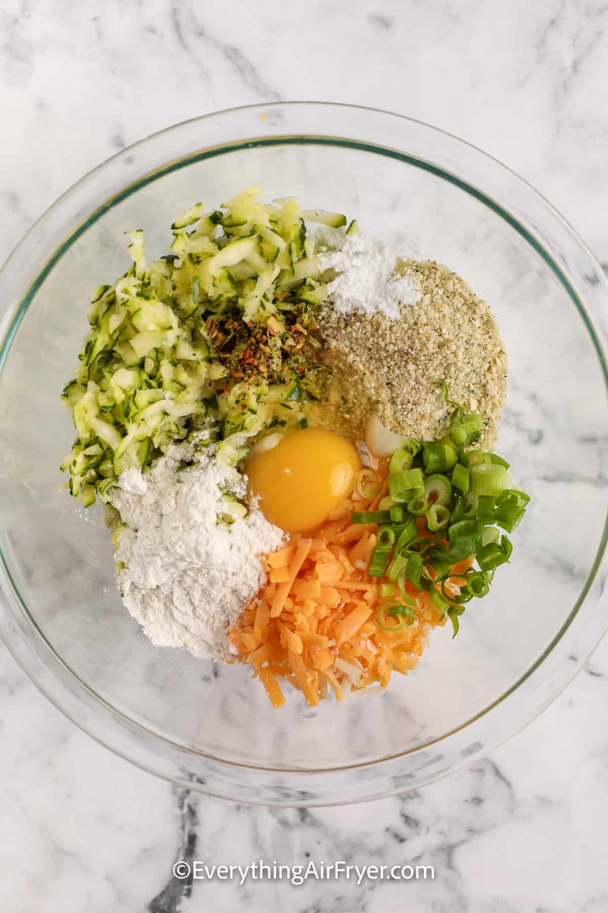 ingredients for air fryer zucchini fritters in a bowl