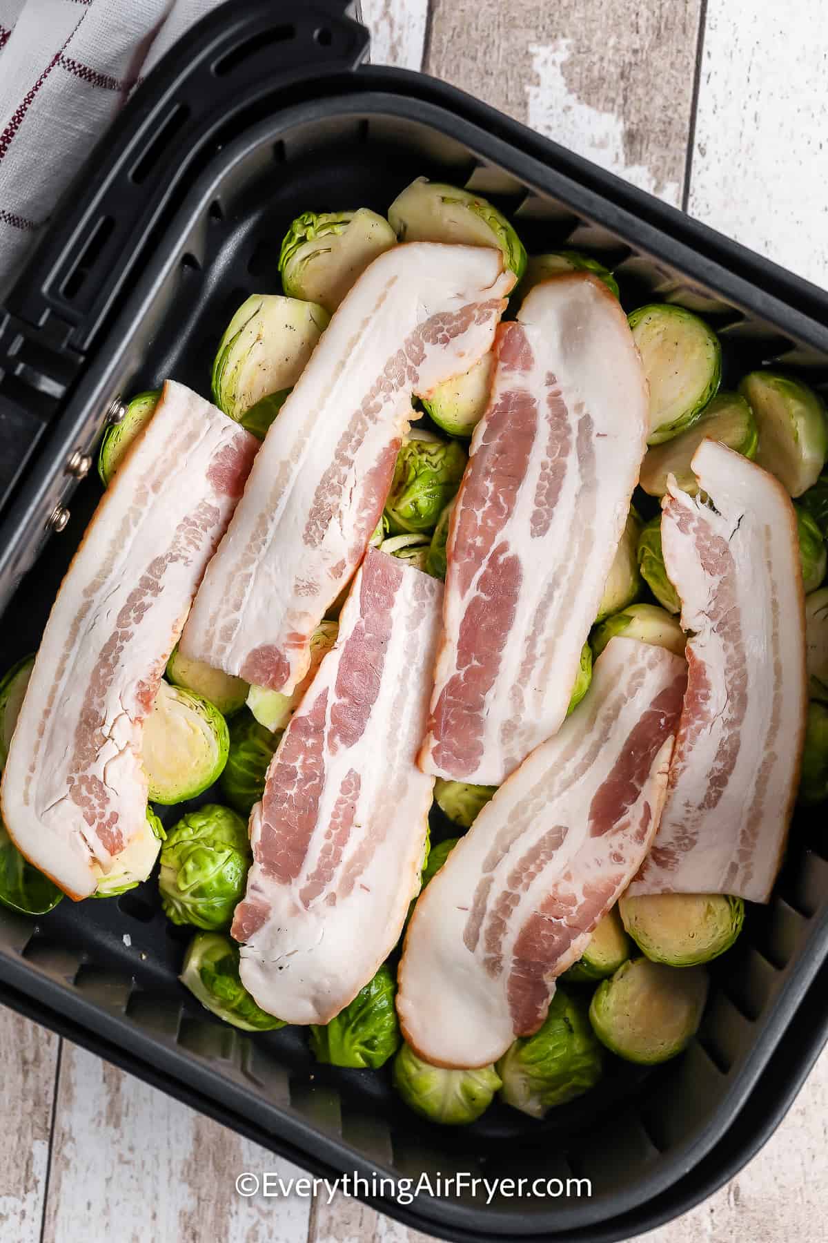 Brussels Sprouts and bacon in an air fryer basket
