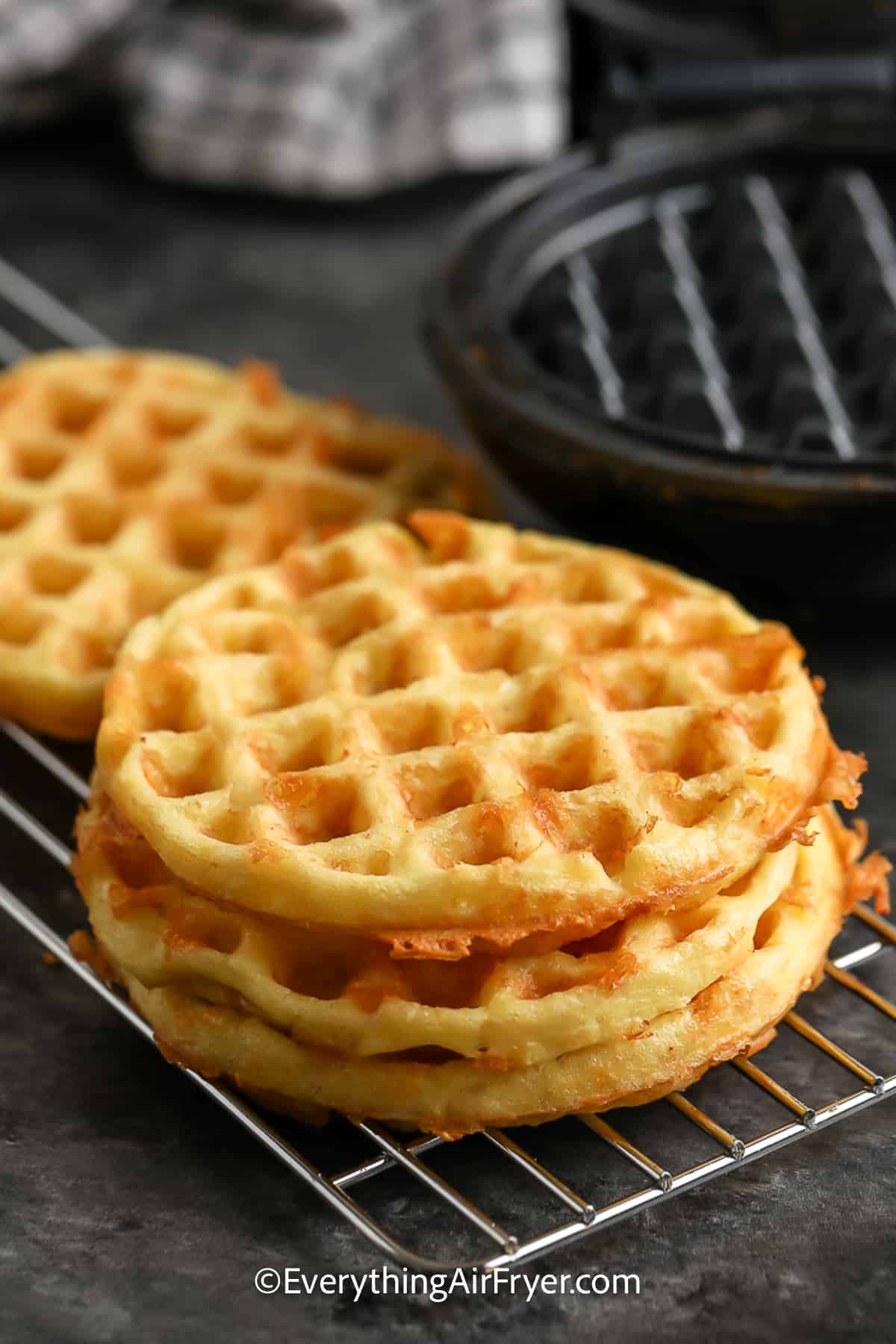 A stack of Chaffles cooling in a baking rack