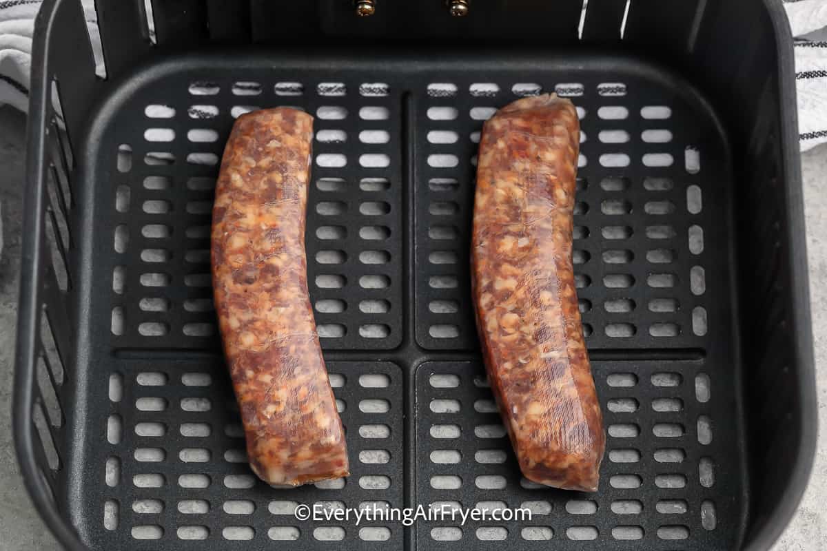 Raw Italian Sausage in an Air Fryer Basket