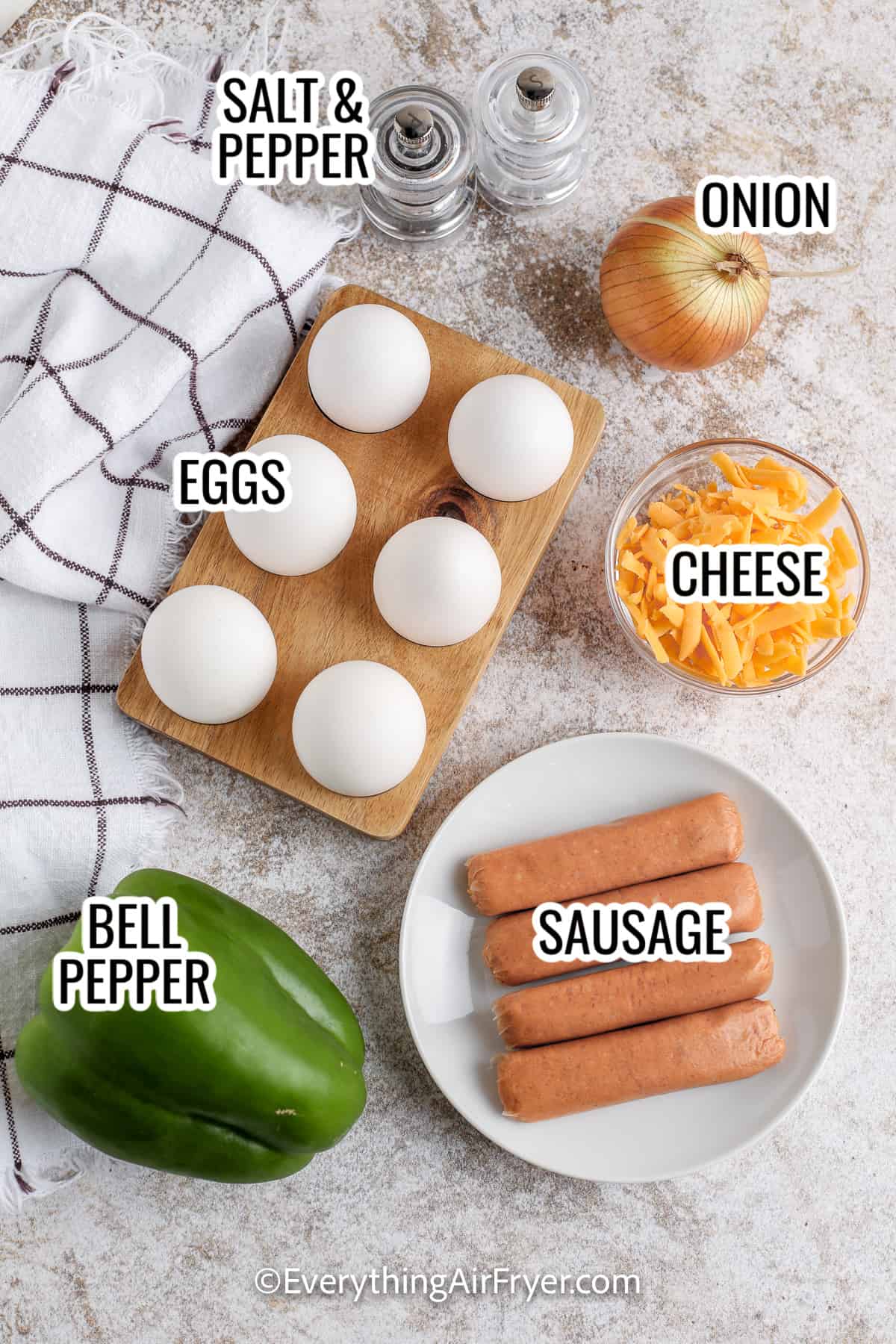 ingredients assembled to make air fryer quiche, including eggs, cheese, pepper, onion, and sausage