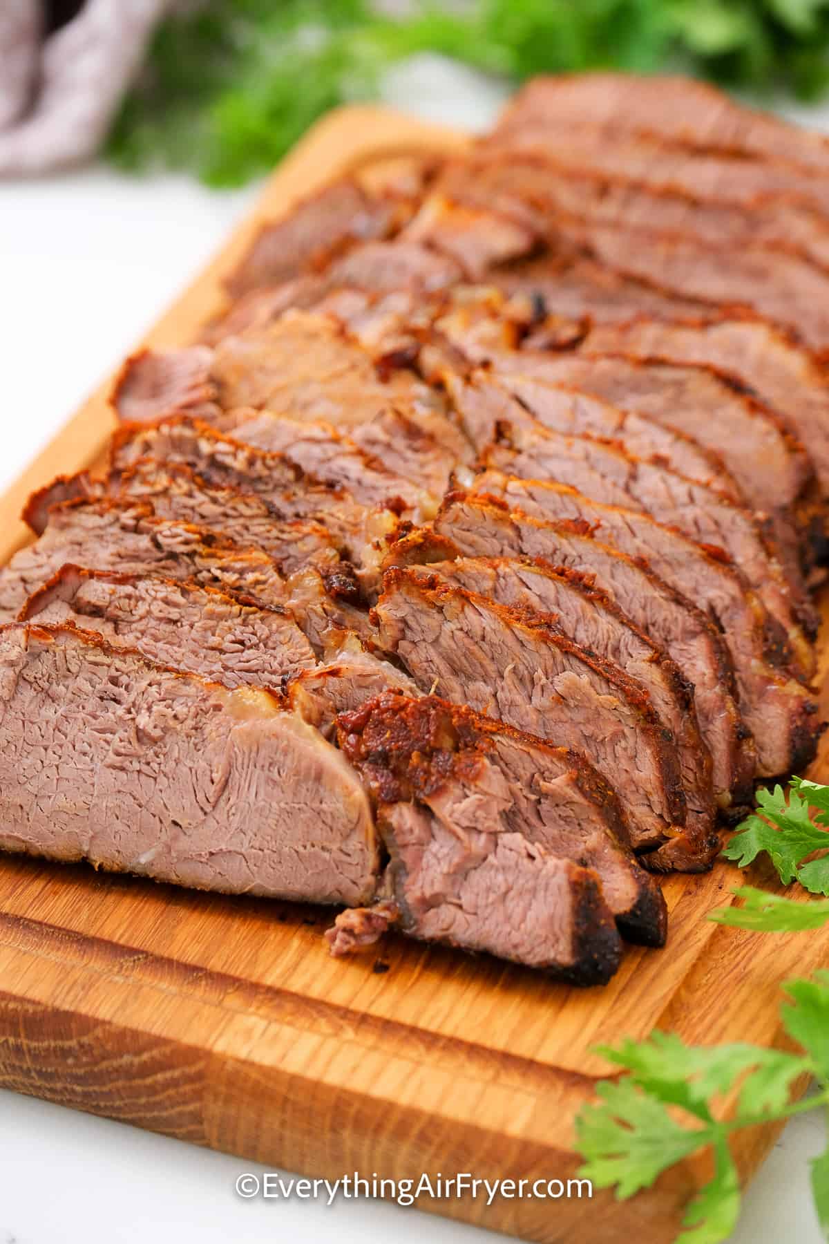 Instant Pot Beef Brisket sliced on a cutting board.