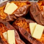 baked sweet potatoes topped with butter with text