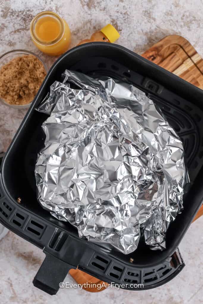 Air Fryer Ham wrapped in foil in the air fryer
