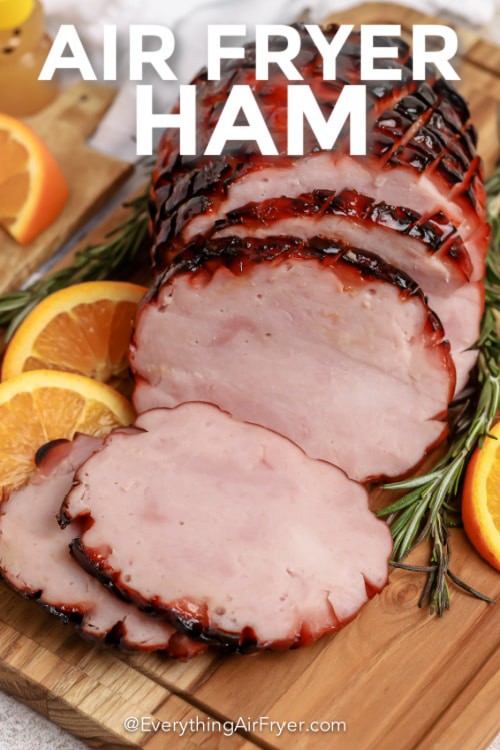 Air Fryer Ham in a wooden board with garnish with writing