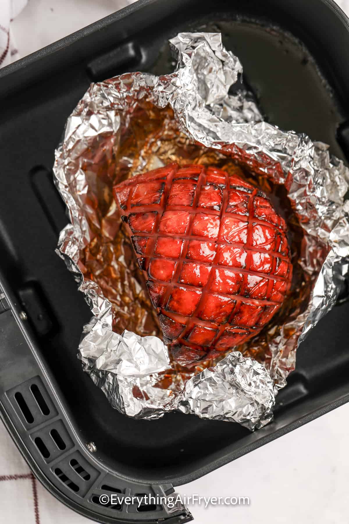glazed ham in an air fryer tray