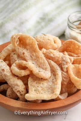 cool ranch pork rinds in a bowl next to cool ranch seasoning