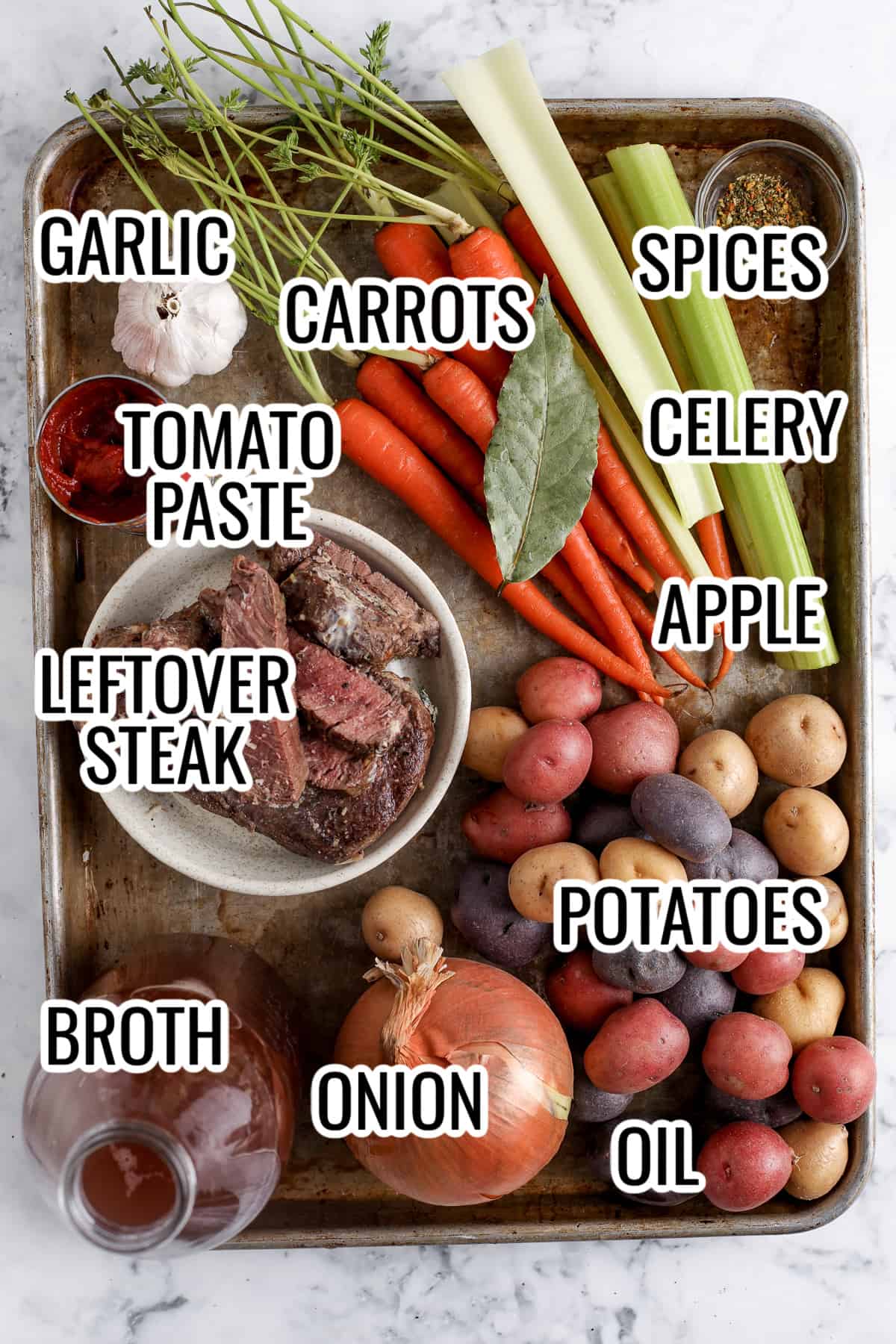 ingredients assembled to make instant pot stew with leftover steak, including potatoes, carrots, celery, steak, broth, onions, and tomato paste