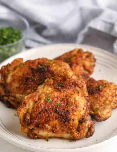 air fryer cajun chicken thighs topped with parsley