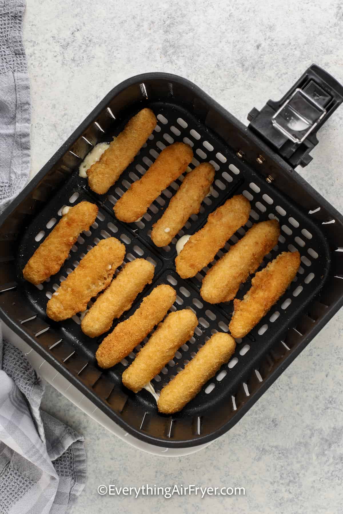 mozzarella sticks in an air fryer tray